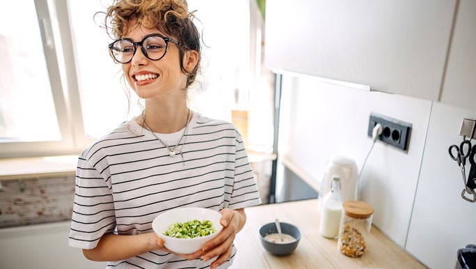 Woman at home eating a healthy breakfast
